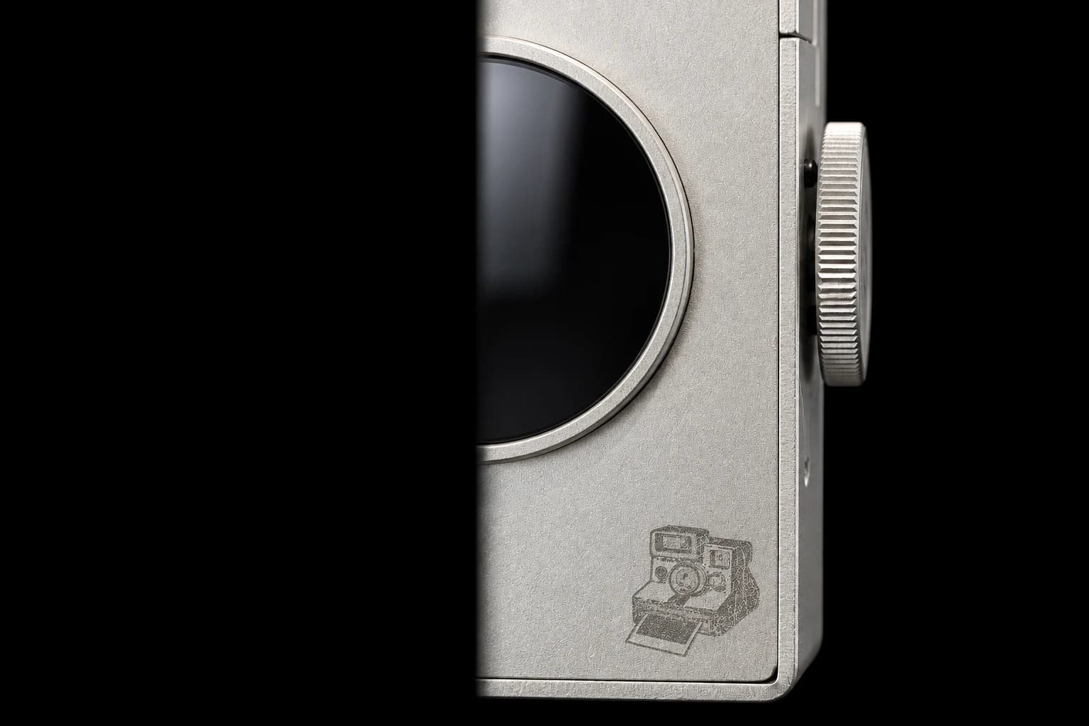 Studio-enhanced photograph of Sticker Camera’s aluminum body, lens ring and knurled dial